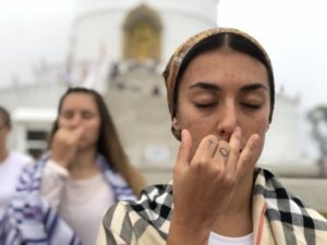 A girl doing breathing practice during Pranayama course in Himalayas