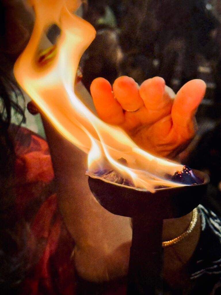 Touching Blessing fire by hand in yoga training in Rishikesh