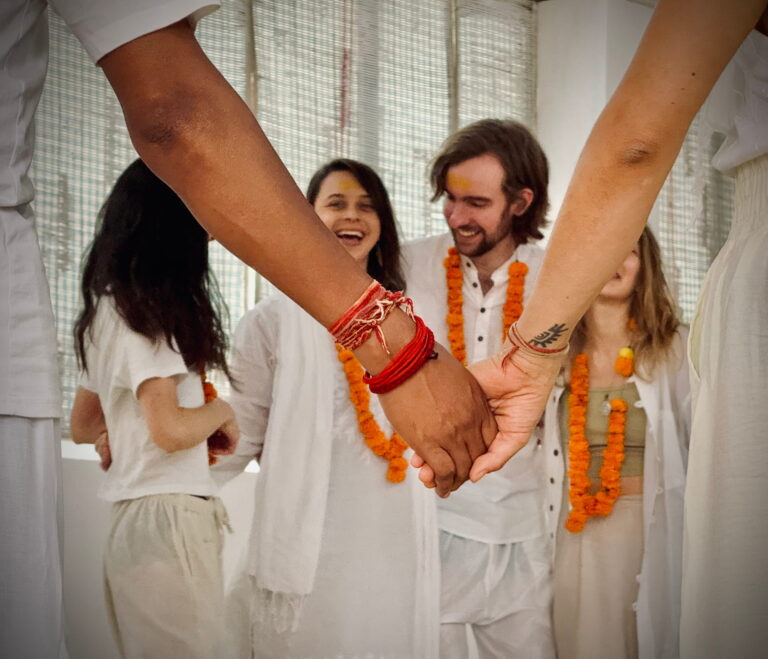 India yoga training ceremony students holding hands