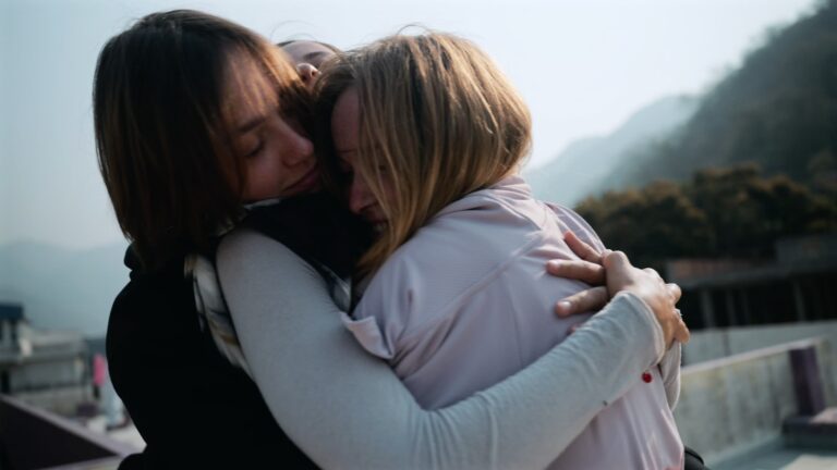 group of students hugging after meditation class