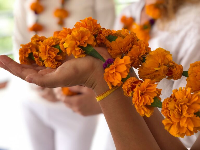 Holding flowers in Ayurveda class during pranayama course nepal