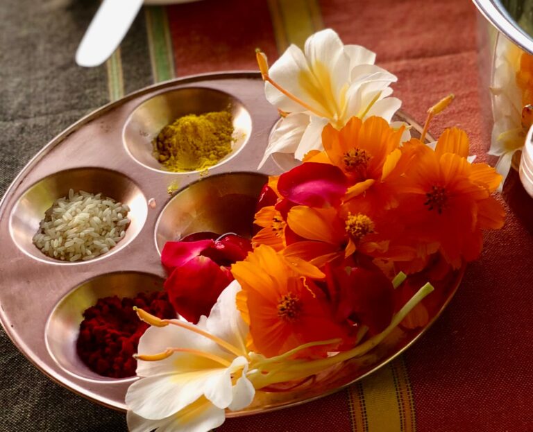 Flowers and ayurvedic herbs in a plate at advance yoga training opening ceremony.