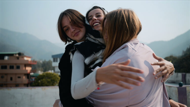 Happy students hugging together at spiritual community in Rishikesh India