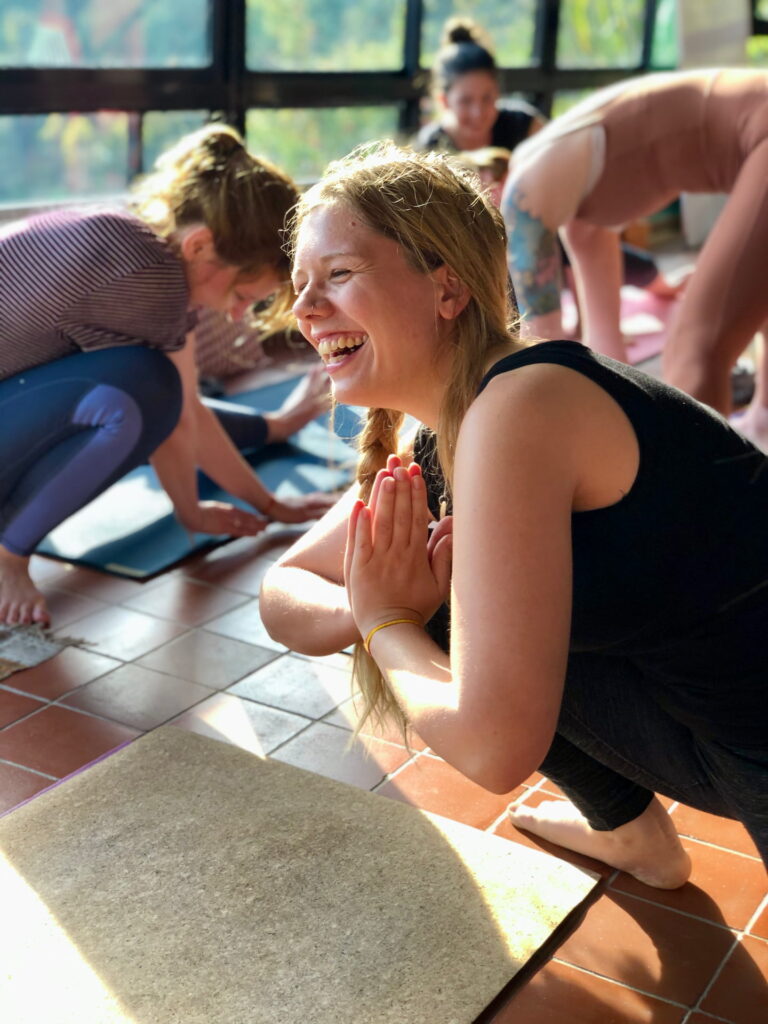 A Student is smiling during Hatha class in yoga teacher training in india