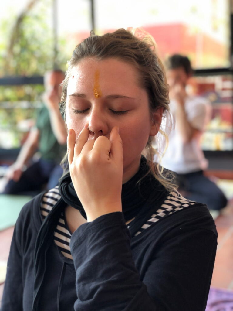 A woman doing moring pranayama class in pranayama teacher certification course