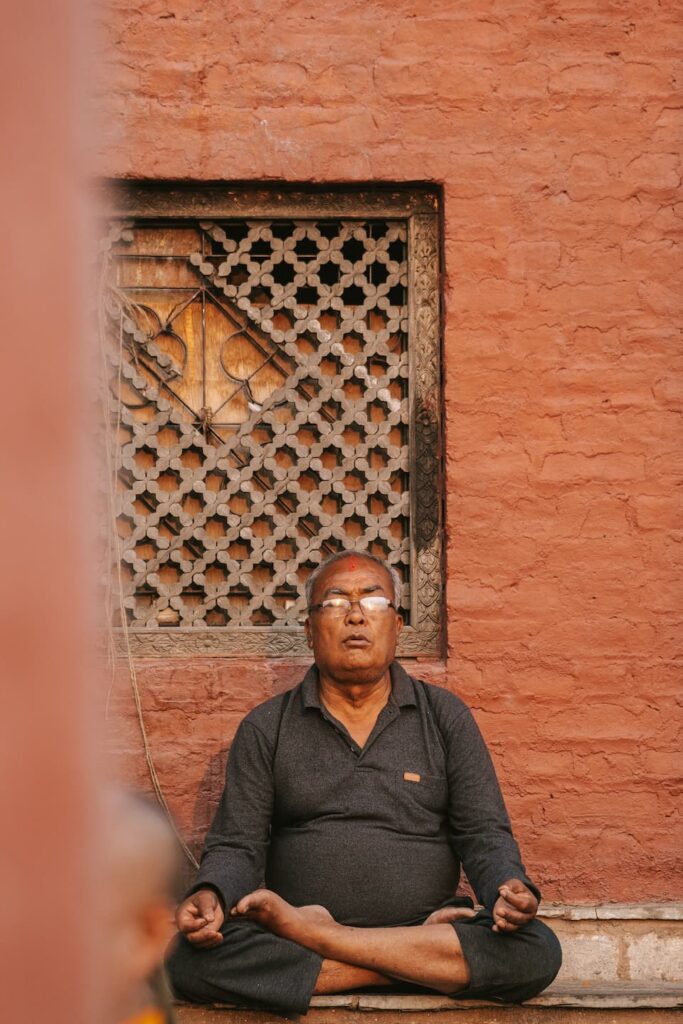 a man sitting in meditation ashram in india