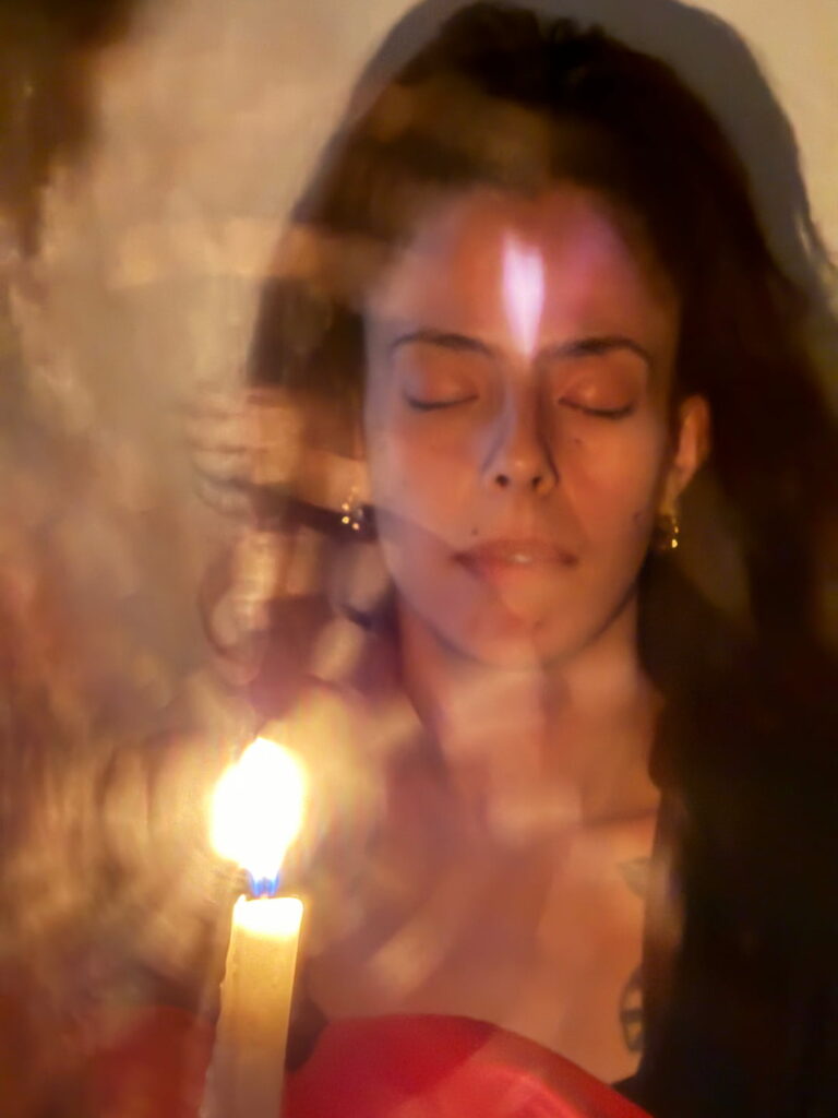 a wonan meditating on candle flame on full moon day