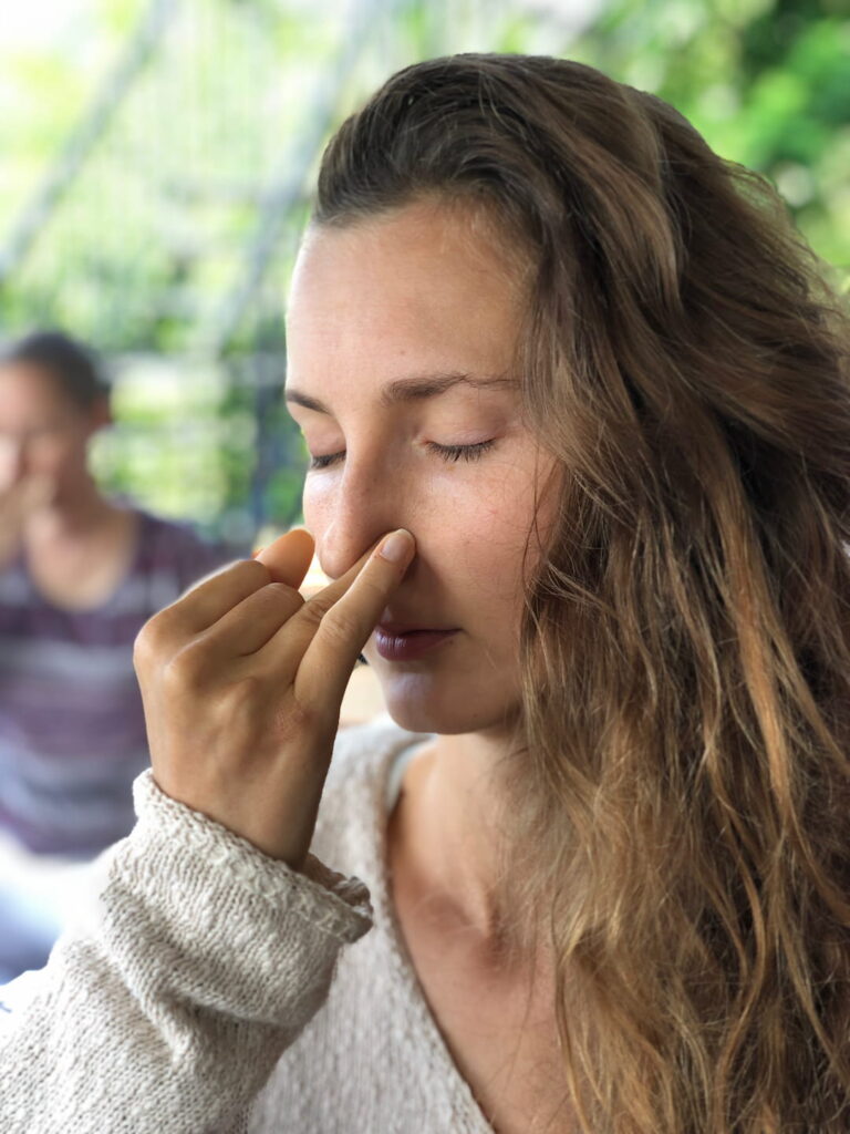 A Woman practicing Nadi Shodhan during her Pranayama teacher training