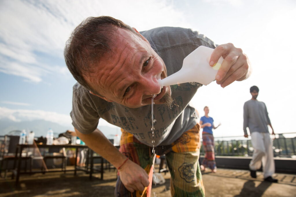 A man doing Morning nose cleansing during Pranayama teacher training